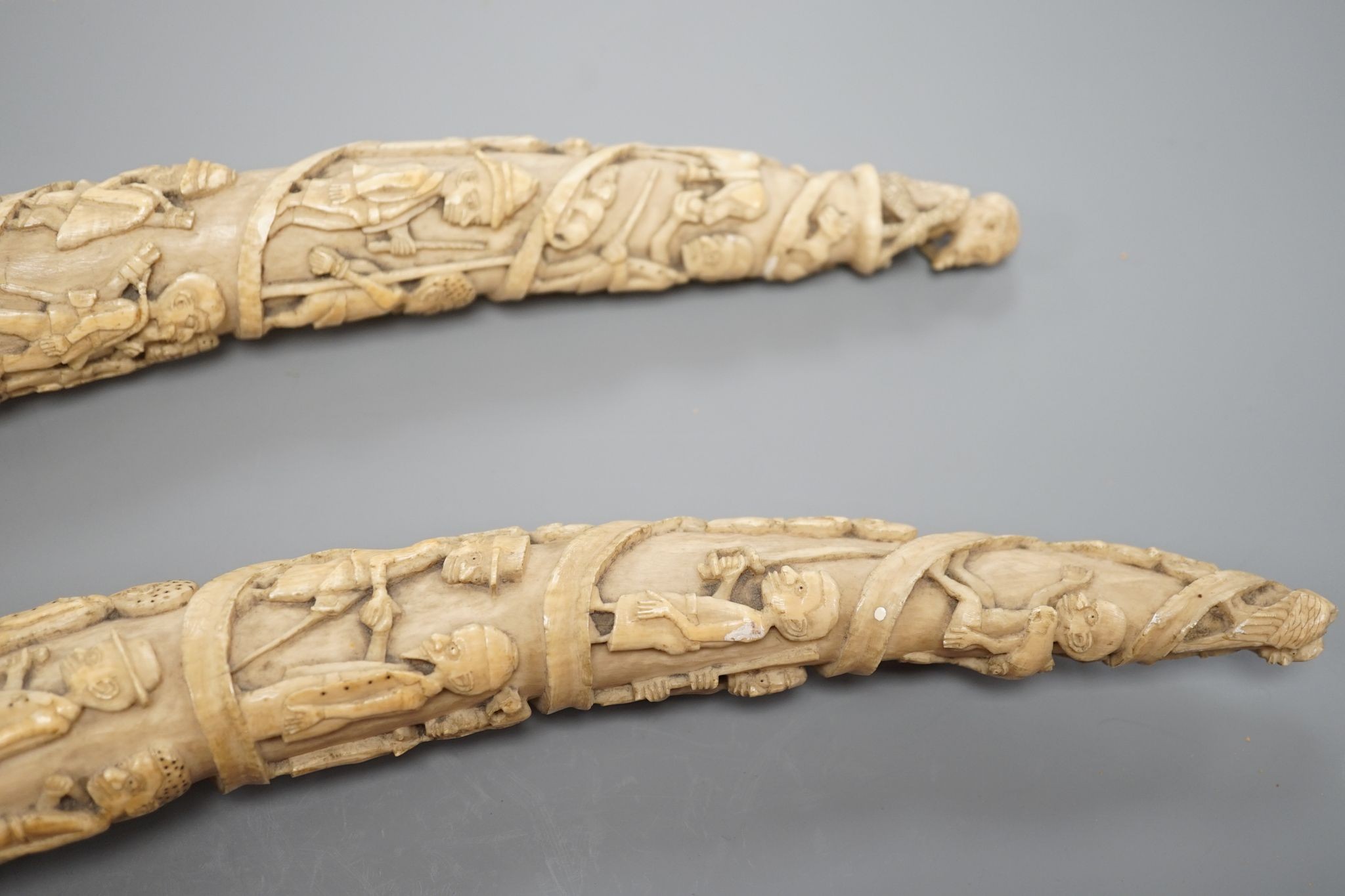 Two Loango carved ivory tusks, Republic of Congo, mid to late 19th century, 46cms long.